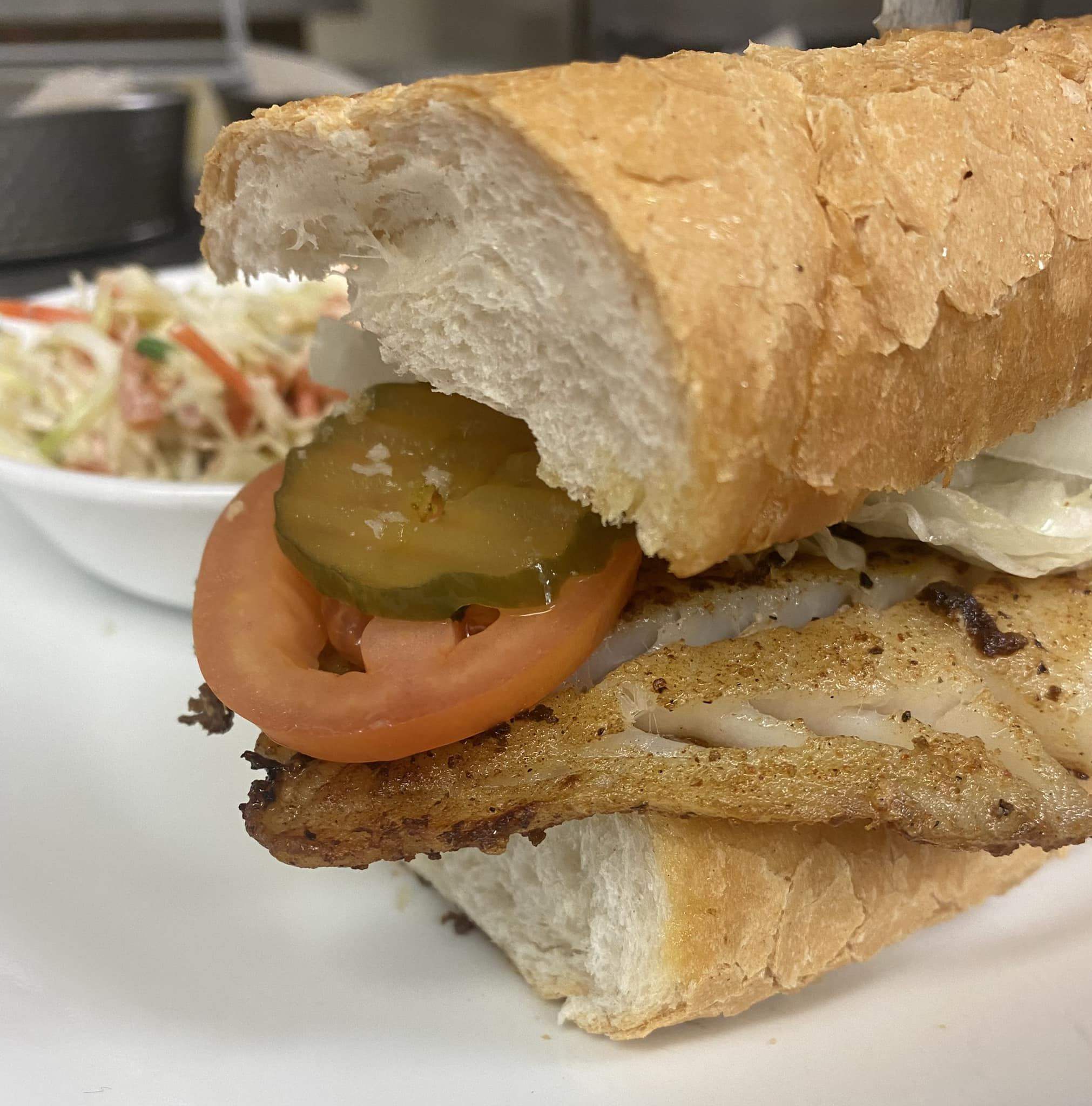 Crispy fish po-boy sandwich with lettuce and remoulade